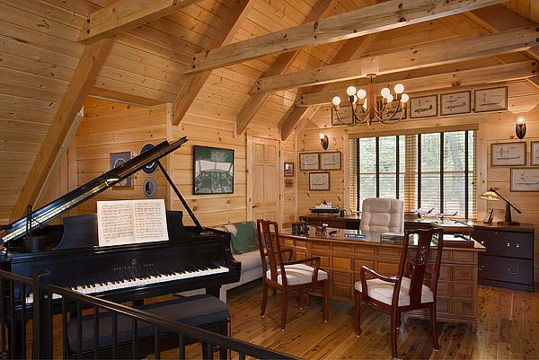 photo of great room area with matching wood exposed beams, ceiling, walls and floors and a built in executive office desk