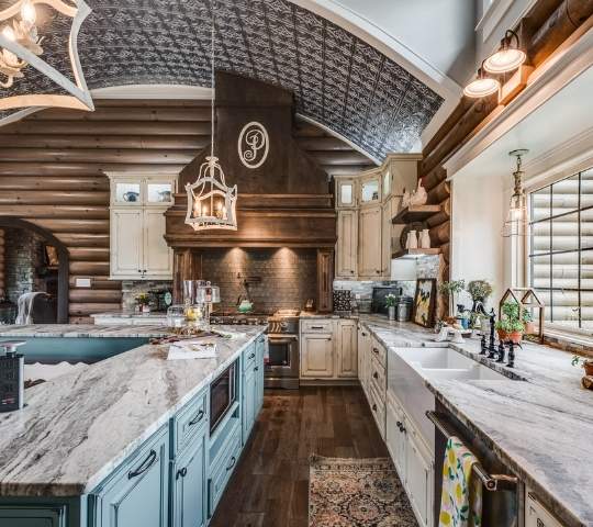 photo of country kitchen with distressed light blue cabinets, marble counters and curved tiled ceiling
