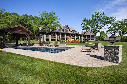 photo of timber frame estate home with outdoor living swimming pool gazebo and gardens